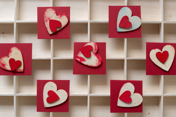 grungy wooden hearts on paper squares on a wooden box