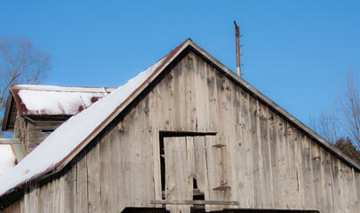 Details of an old barn in a winter countryside landscape in Quebec, Canada