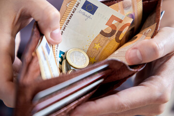 man hand putting money, closeup