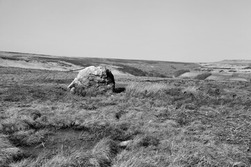 pennine landscape with large old boulder or standing stone on midgley moor in west yorkshire