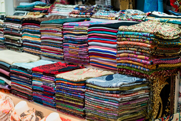 Turkish made textiles in shop in the Grand Bazaar, Istanbul. Scarves, Hand-loomed carpets and kilims, many of the types products with flat-weaves