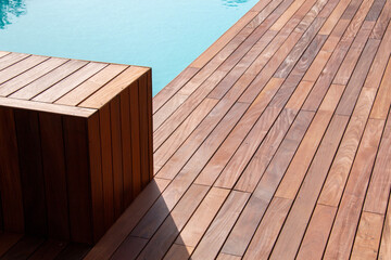 Texture with tiled wooden decorative planking, hardwood ipe pool deck on direct sun heat.