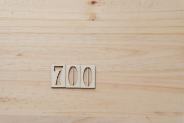the number 700 on a wooden surface with blank space