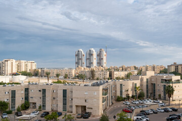 Obraz premium Contrast Architecture in Israel, modern tower skyscrapers and old buildings in Beer Sheba Neighbourhood. Old and new development architecture concept