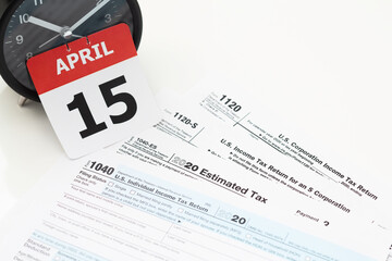 April 15 Tax Day deadline concept - calendar page, tax returns, and clock