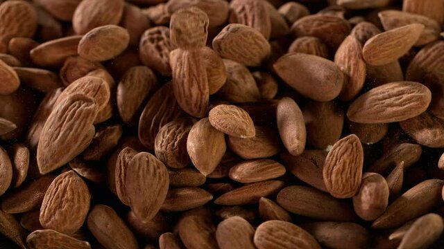 Super slow motion of falling raw almonds at 1000 fps. Filmed on high speed cinematic camera.