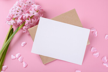 Blank wedding invitation stationery card mockup with envelope on pink background with hyacinth...