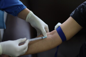 Close up Hand of nurse, doctor or Medical technologist in blue gloves taking blood sample from a patient in the hospital. - obrazy, fototapety, plakaty