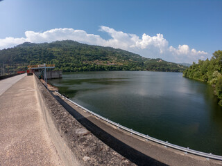Sao Cristovao de Nogueira, Cinfaes, Portugal, June 11, 2021: The Barragem do Carapatelo (Carapatelo Dam) is situated in river Douro, on the border of the districts of Porto and Viseu in Portugal. - obrazy, fototapety, plakaty