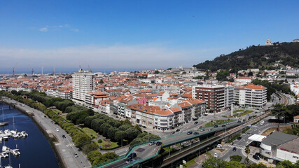 Naklejka premium Viana do Castelo, Portugal, June 10, 2021: The Gustave Eiffel Bridge over the river Lima in Viana do Castelo. Aerial panoramic cityscape view of Viana and the Marina.
