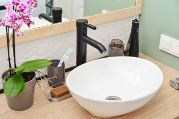 Stylish vessel sink with black basin mixer