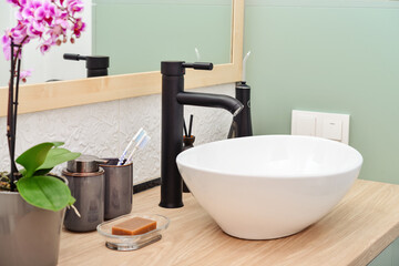 Stylish vessel sink with black basin mixer