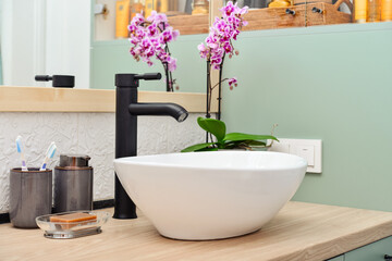 Naklejka na ściany i meble Stylish vessel sink with black basin mixer