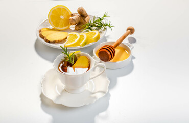 Ginger, lemon and herbs infusion tea served in a white porcelain cup. Copy space. 
