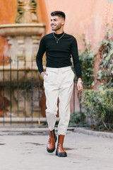 Attractive caucasian man looking distracted while walking on the street