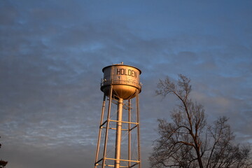 Water Tower Under a Blue Cloudy Sky