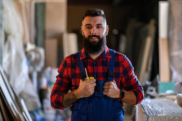 Young male carpenter working in workshop