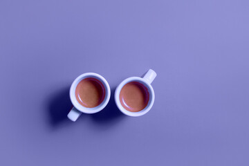 Two cups of coffee espresso top view on purple background. Fika concept