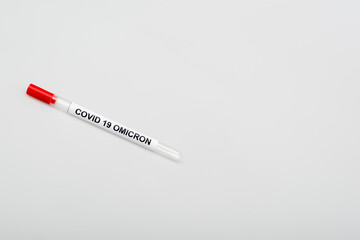 top view of covid-19 omicron test tube on grey background with copy space.
