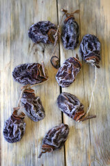 Dried persimmon on a wooden surface. Close.