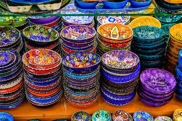 Many colorful souvenir plates for sale at the bazaar in Turkey