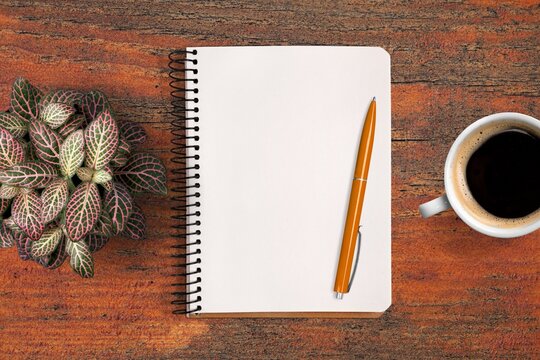New year goals 2022 concept on desk. notebook, coffee cup  on wooden background.
