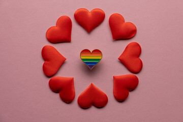 Heart shaped badge with Lgbt gay rainbow flag on pink background. LGBT Valentine's day concept.