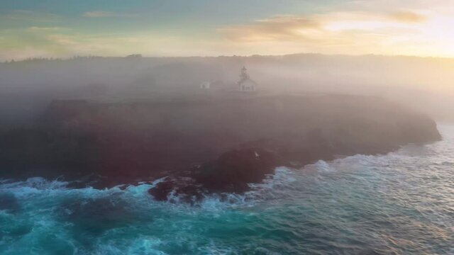 Calm and magical sunrise at picturesque cape. Aerial footage breathtaking natural scenery with operating beacon. High quality 4k footage. Point Cabrillo Lighthouse station, West Coast, California USA