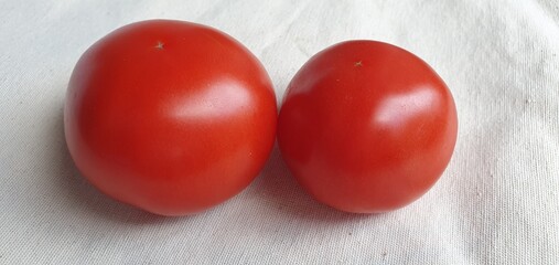 Two ripe tomatoes close up. Fresh red tomatoes.