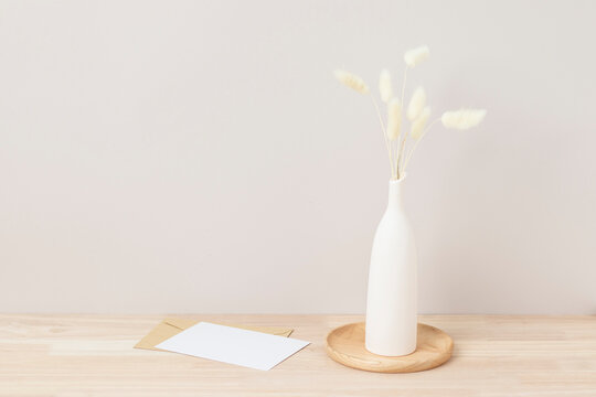 Home interior floral decor, pampas grass on table, Front view, blank paper card, Greeting card Mockup. Beautiful white pampas grass in vase on white background