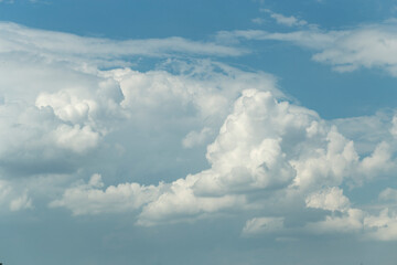 Cumuliform cloudscape on sky. Panorama. The sun is hidden.  Cumulonimbus clouds.