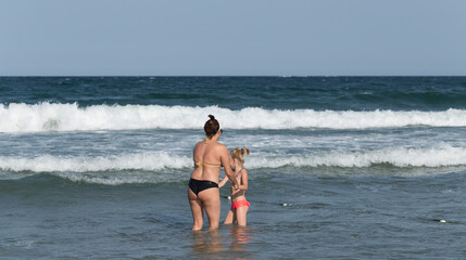 Kiten, Burgas Province, Bulgaria. Holidaymakers, on the Black Sea coast. People sunbathe on the beach and swim in the sea.