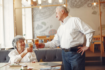 Fototapeta na wymiar Beautiful old couple sitting in a cafe