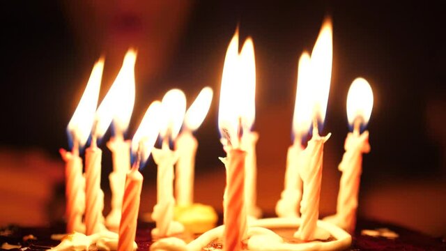 A child blows out the candles on the cake in your birthday. 10 years