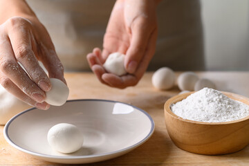 Obraz na płótnie Canvas Hand making Tangyuan, Chinese dessert made of ball glutinous rice flour