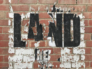 Old paper posters on a red brick wall