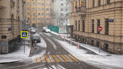 Snowfall on road and crosswalk