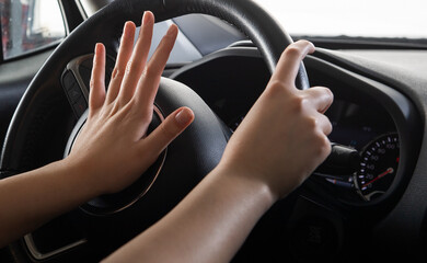 Angry girl driving a car and beeps,closeuo