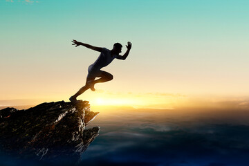 Man running against sunset sky background