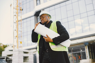 Black architect with project talk by phone