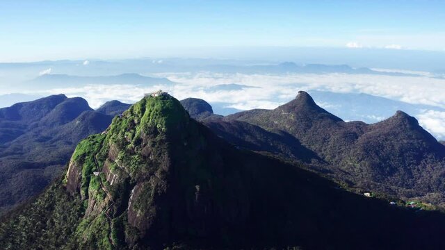 Adam's Peak is a 2243 m tall conical mountain located in central Sri Lanka - Sacred Mountain for four religions with a temple on a top. 4K aerial flying drone footage. 
