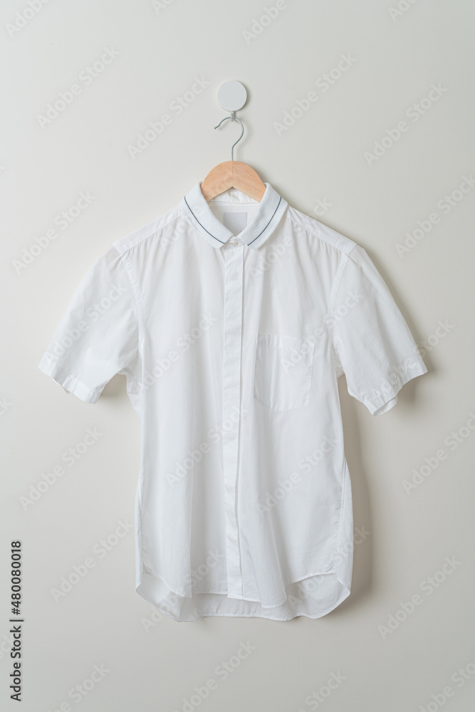 Canvas Prints hanging shirt with wood hanger on wall