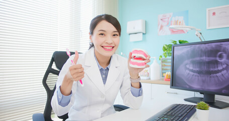 female dentist at dental clinic - obrazy, fototapety, plakaty