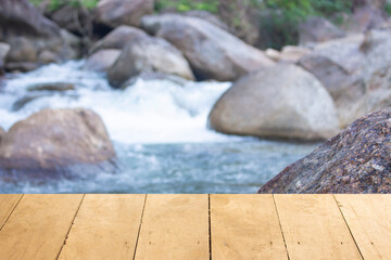 Wooden table behind the beautiful waterfall