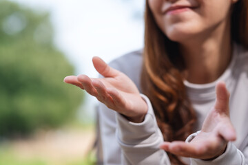 Closeup image of a young woman talking with body language