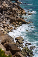 Sunny rocky shore with beautiful sea in Nazaré, Portugal