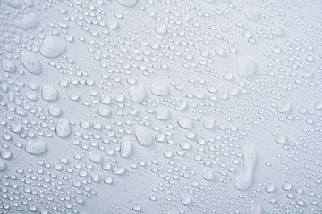 Transparent water droplets from spray on white background