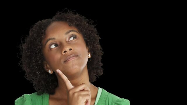 A cinemagraph of a woman looking up in thought moving her finger back and forth against her chin. Alphamatte included.