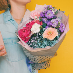 A bouquet of flowers in the hands of a woman