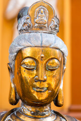 Fototapeta na wymiar Face portrait of the ancient statue of Guanyin, Guan Yin or Kuan Yin